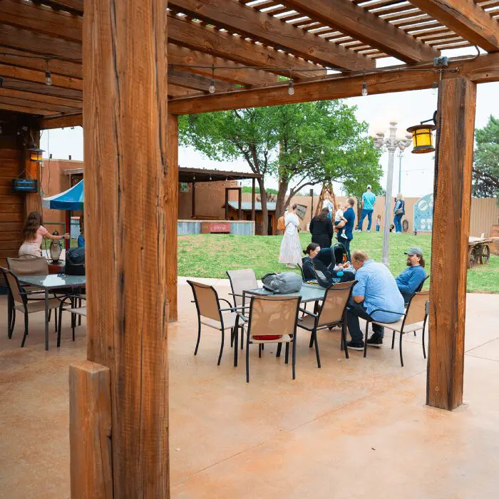 Outdoor patio with people sitting and walking.