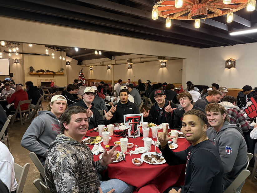 Group of friends enjoying a meal together at a round table.