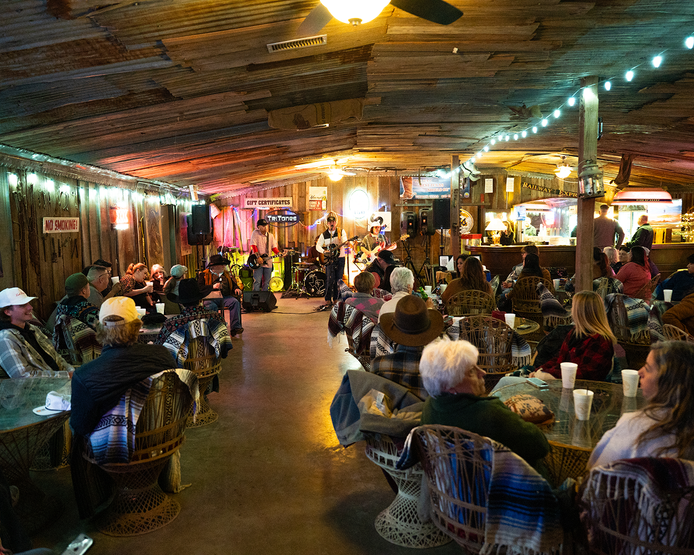 Cozy rustic restaurant filled with people dining and socializing.
