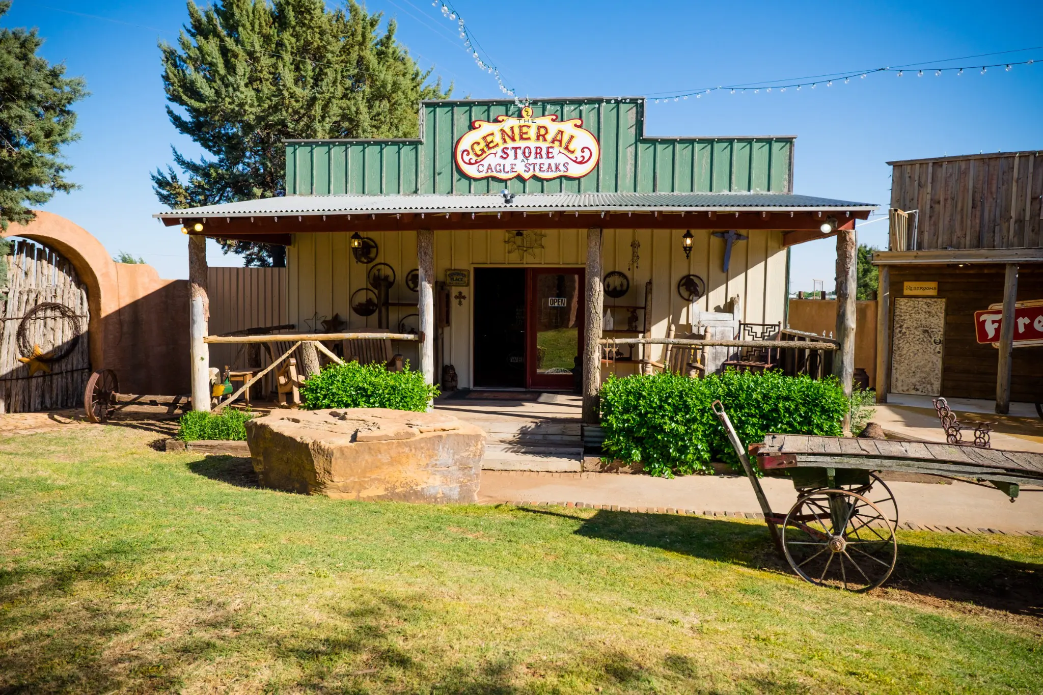 Rustic general store with a green roof and wooden porch.
